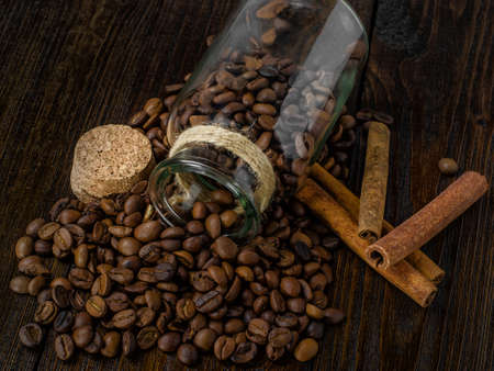 Coffee in a vintage jar, cinnamon  on wooden table, closeupの写真素材