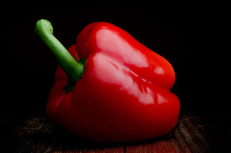Red pepper on a wooden table, closeupの写真素材
