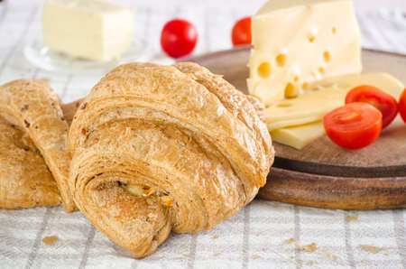 Morning breakfast with croissant, cheese and tomatoes.の写真素材