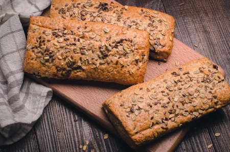 Healthy rye-wheat sourdough bread. Homemade whole grain fitness bread sprinkled with oat flakesの写真素材