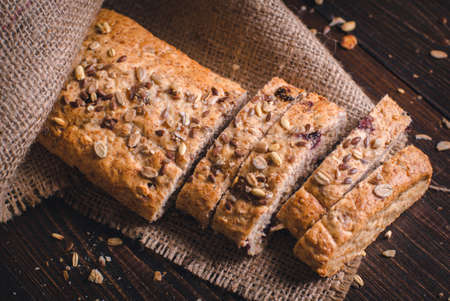 Sliced healthy bread. Homemade whole grain fitness bread sprinkled with seeds.