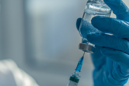 The doctor fills the syringe with medicine. A nurse in a hospital laboratory prepares for injectionの写真素材