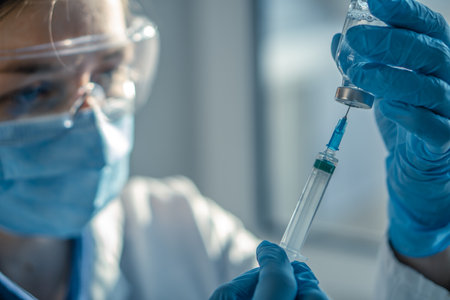The doctor fills the syringe with medicine. A nurse in a hospital laboratory prepares for injectionの写真素材