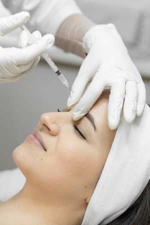 Skin renewal, where the botulinum therapy procedure makes a womans skin young, moisturized and expressive, giving her a new freshness. Injection for wrinkle consideration and facial skin careの写真素材