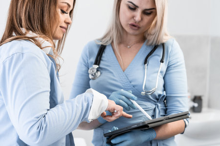 Health in focus: The doctor discusses the test results and reveals the diagnosis on a tablet, expanding the patients knowledge of her health. Medical examination: A woman on a visit to a doctor whoの写真素材