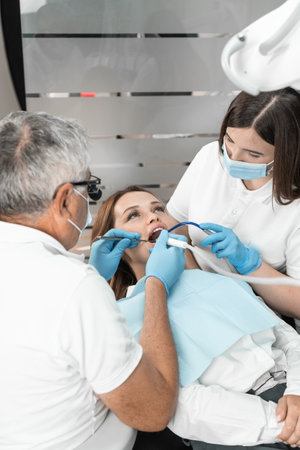 A dentist provides professional diagnostics and effective treatment aimed at solving specific oral health problems. Her expertise guarantees a successful outcome.の写真素材