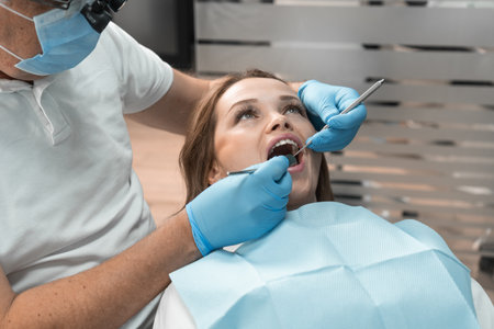 The dentist in clinic conducts professional treatment patients teeth using advanced methods and technologies. Her attention to detail and specialized skills ensure effective and painless treatment.の写真素材