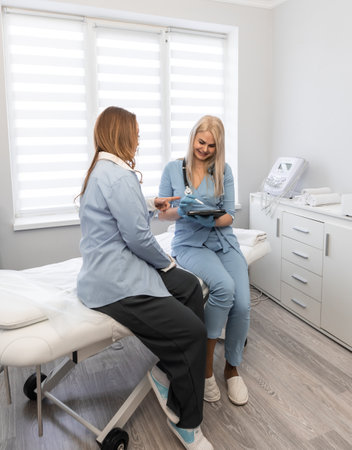 Health journey: The photo captures a womans medical visit, during which the doctor details the prescribed procedures and sets the stage for a joint treatment plan.の写真素材