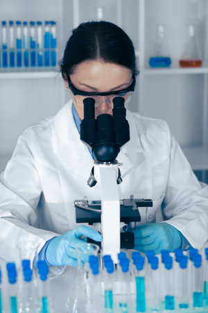 A skilled scientist is analyzing diverse samples under a highresolution microscope, advancing scientific knowledge, research outcomes, and impactful discoveries in the relevant field of studyの写真素材
