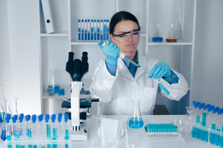 A dedicated scientist conducts a detailed lab experiment using advanced equipment to uncover groundbreaking findings in biology, chemistry, and biotechnology, enhancing our understandingの写真素材
