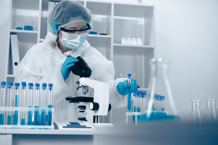 In a contemporary laboratory setting, a researcher is diligently analyzing various samples. This work encompasses multiple fields such as biomedical science, biotechnology, and chemistryの写真素材
