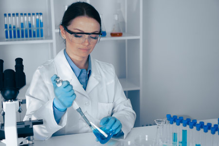 A dedicated scientist conducts vital lab research in biomedical studies and biotechnology, using precise instruments like pipettes to advance healthcare and enhance technology for societys benefitの写真素材
