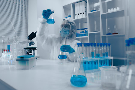 A dedicated scientist is actively conducting a detailed experiment in a stateoftheart modern laboratory, utilizing advanced techniques and an array of tools to explore new scientific ideasの写真素材