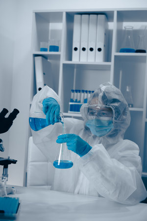 A dedicated scientist is meticulously conducting a complex experiment in a stateoftheart modern laboratory, equipped with advanced technology and essential tools for groundbreaking researchの写真素材