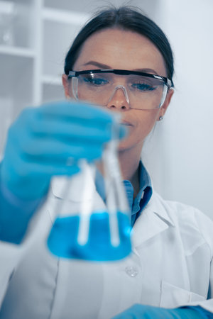 A dedicated scientist is meticulously analyzing a complex chemical solution within a wellequipped laboratory, gaining insights that contribute to the broader fields of chemistry and scienceの写真素材