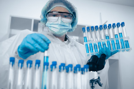 A skilled and meticulous Laboratory Technician expertly handling various test tubes within a cuttingedge laboratory setting, ensuring precision and accuracy during crucial experiments and analysesの写真素材