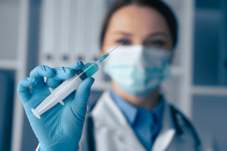 A dedicated healthcare professional, equipped with a syringe, is committed to ensuring patient safety, overall wellness, and effective immunizations and treatments in a clinical settingの写真素材