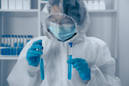 A skilled scientist conducts a precise experiment with test tubes in a modern lab, embodying years of research and significant discoveries in the evolving field of science and technologyの写真素材