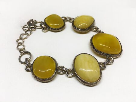 Silver bracelet with yellow Baltic amber. Template for jewelry store design.の写真素材