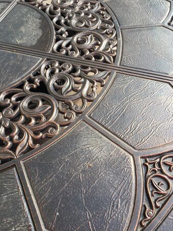  Gray surface of an iron forged table with carvings. Forged Workshop Background Template