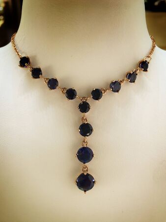 Gold sapphire necklace on a jewelry stand. luxury jewelry.の写真素材