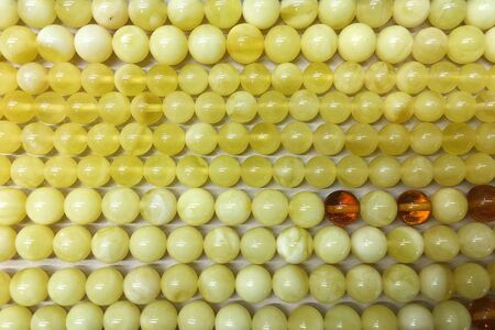 Background of white amber balls on a flat surfaceの写真素材