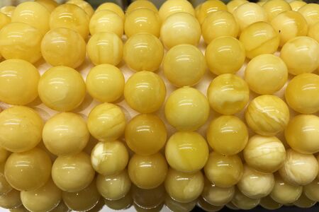 Bracelets made of white Baltic amber balls on a jewelry standの写真素材