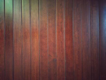 Brown vertical lacquered plank surface. Natural dark wood background for design.の写真素材