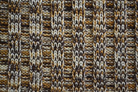 Knitted texture pattern melange in dark brown tones. Fashionable concept.
