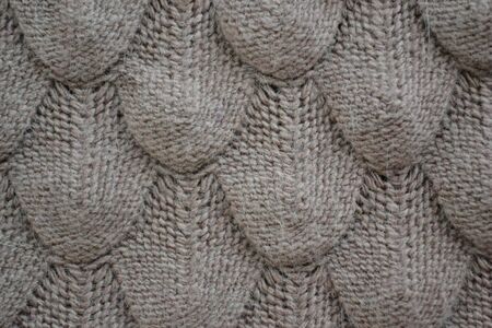 Knitted texture with patterns in light brown.Fashionable concept.の写真素材