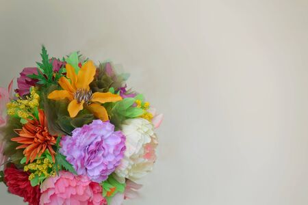 A round bouquet of different flowers on a neutral background. Place for text. Template for postcard, background, poster, site. Horizontal image format. High quality photoの写真素材