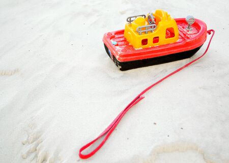 Childrens toy boat on the white sand.の写真素材
