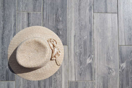 A beige sun hat lies on a gray backgroundの写真素材