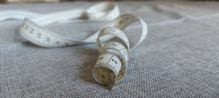 Measuring tape for a tailors work is twisted in a spiral