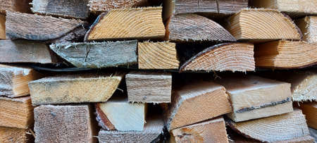 The ends of straight sawn boards. Natural wood background.