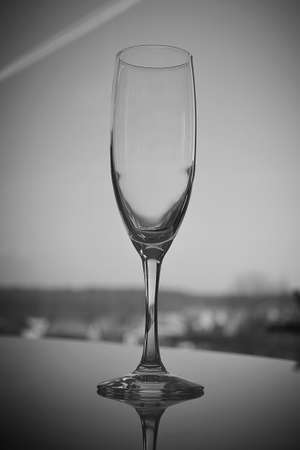 An empty transparent elegant tall glass stands on the tableの写真素材