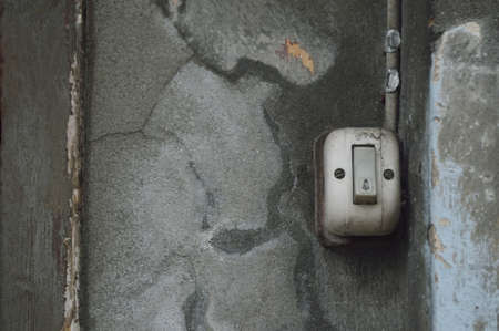 Old electric switch on grunge brick wallの写真素材