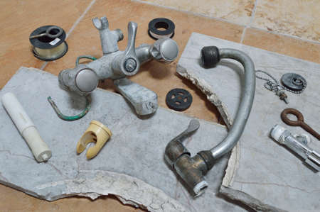 old metal faucet on tile backgroundの写真素材