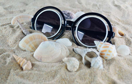 Sunglasses and shells on the beach sand, Summer Backgroundの写真素材
