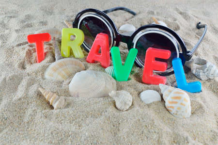 Travel colorful text on the beachの写真素材