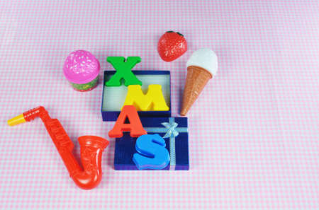 Christmas decoration with colorful toys on pink background