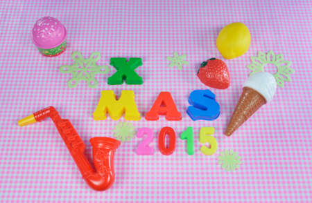 Christmas 2015 decoration with colorful toys on pink backgroundの写真素材