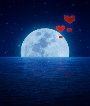 Red fabric heart air balloon on fantasy sky and moonの写真素材