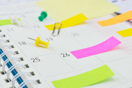 Colorful post It notes with pin and clip on business diary pageの写真素材