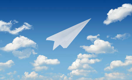 Airplane paper flying in blue sky leader business conceptの写真素材