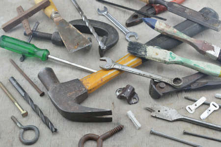 Assorted old work tools on wooden boardの写真素材