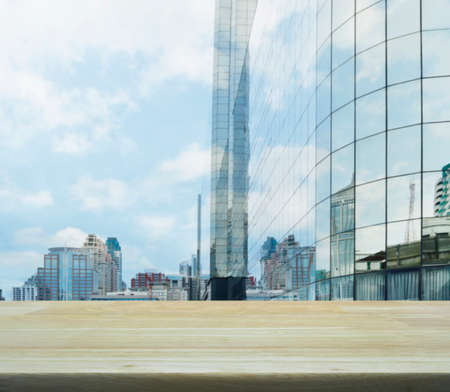 Wooden table over business tower background