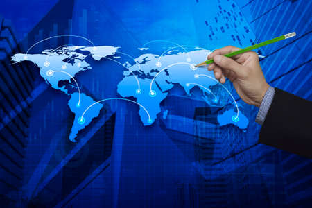 Businessman hand holding a pencil pointing at global business connection map, Elements of this image furnished by NASAの写真素材