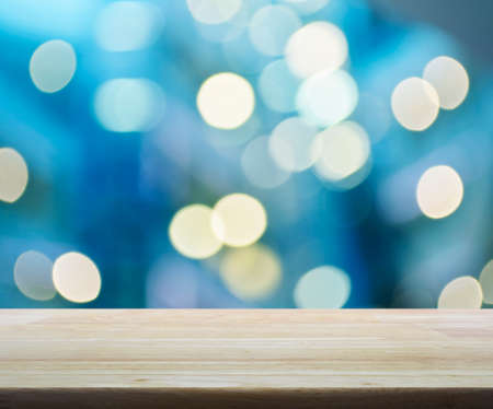 Empty wooden table over blurred mall bokeh background, product displayの写真素材