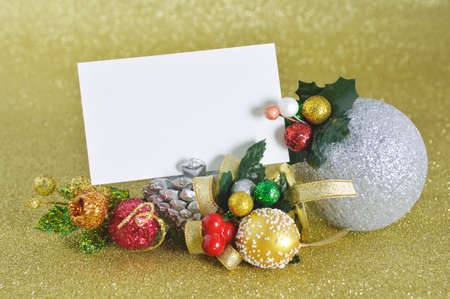 Blank christmas card with christmas ornament on gold backgroundの写真素材